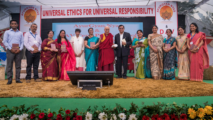 His Holiness the Dalai Lama and representatives from 9 schools releasing the Universal Ethics Curriculum prepared by Ayurgyan Nyas during the program at CJ DAV Public School in Meerut, UP, India on October 16, 2017. Photo by Tenzin Choejor