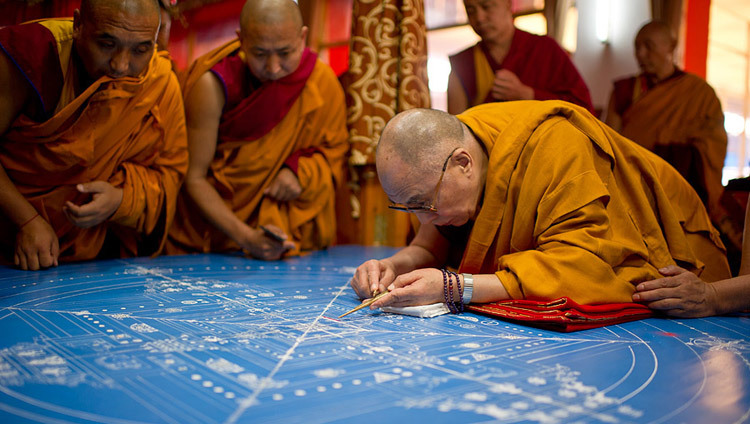 His Holiness the Dalai Lama placing the first grains of colored sand to start the construction of the Kalachakra sand mandala during the 32nd Kalachakra Empowerment in Bodhgaya, Bihar, India on January 1, 2012. (Photo by Tenzin Choejor/OHHDL)