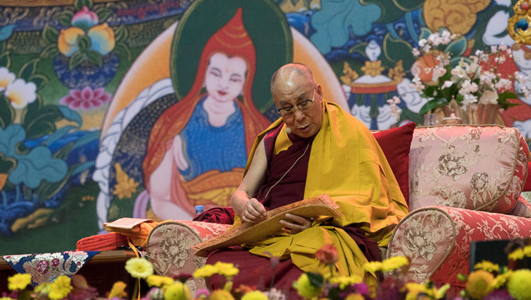 His Holiness the Dalai Lama reading from the text during his teaching in Riga, Latvia on October 11, 2016. Photo/Tenzin Choejor/OHHDL