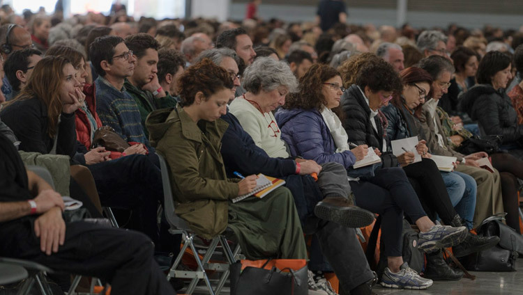 Members of the audience taking notes during His Holiness the Dalai Lama's teaching in Milan, Italy on October 21, 2016. Photo/Tenzin Choejor/OHHDL