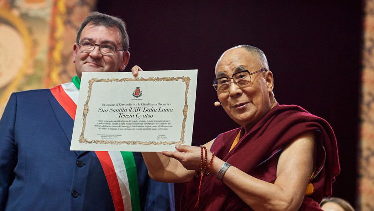 Mayor of Rho, Pietro Romano presenting His Holiness the Dalai Lama with honorary citizenship at the start of his talk in Milan, Italy on October 22, 2016. Photo/Olivier Adam