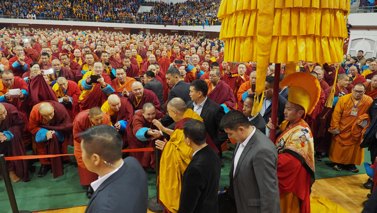 His Holiness the Dalai Lama greeting members of the audience as he at the Buyant Uhaa Sports Complex in Ulaanbaatar, Mongolia on November 20, 2016. Photo/Tenzin Taklha/OHHDL