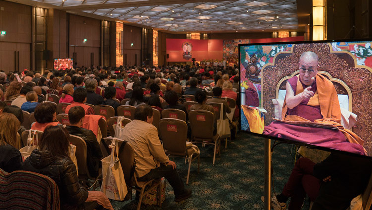 People in the back of the hall watching His Holiness the Dalai Lama on TV screens during his teaching in Delhi, India on December 25, 2016. Photo/Tenzin Choejor/OHHDL