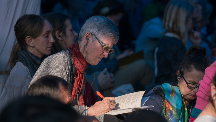 One of the many foreigners attending the Kalachakra Empowerment taking notes during His Holiness the Dalai Lama's Kalachakra preliminary teaching in Bodhgaya, Bihar, India on January 6, 2017. Photo/Tenzin Choejor/OHHDL