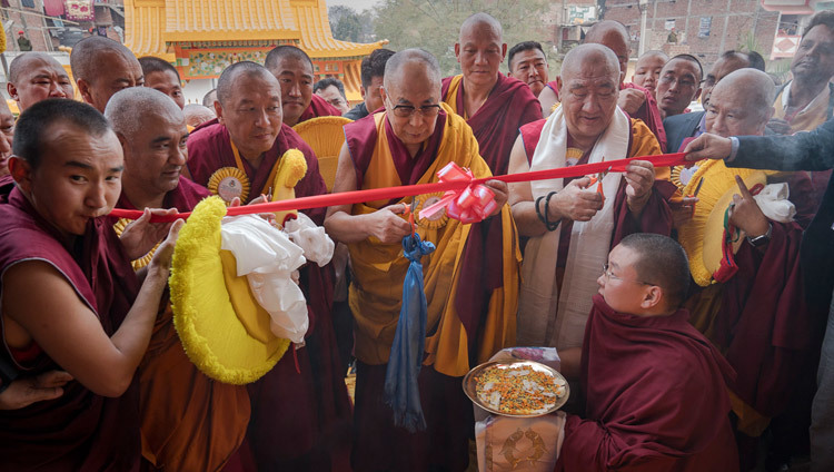 His Holiness the Dalai Lama cutting a ribbon to formally open Gandantecgchenling Mongolian Temple in Bodhgaya, Bihar, India on January 9, 2017. Photo/Tenzin Choejor/OHHDL