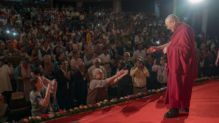 His Holiness the Dalai Lama greeting members of the audience on his arrival on stage at the ITA Centre for Performing Arts in Guwahati, Assam, India on April 1, 2017. Photo by Tenzin Choejor/OHHDL