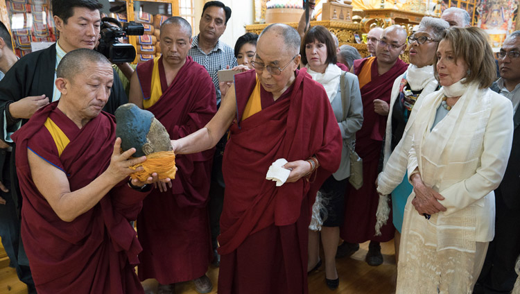 His Holiness the Dalai Lama showing members of the bipartisan US Congressional Delegation part of a statue destroyed by the Chinese as he guides them on a tour of the Main Tibetan Temple Dharamsala, HP, India on May 10, 2017. Photo by Tenzin Choejor/OHHDL