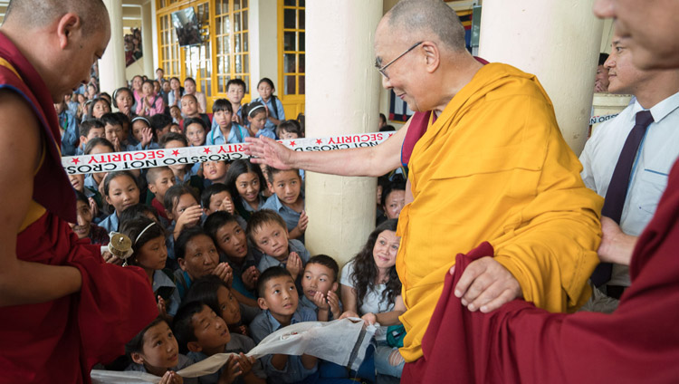 His Holiness the Dalai Lama greeting young Tibetans as he departs the Main Tibetan Temple at the conclusion of the second day of his teaching for Tibetan youth in Dharamsala, HP, India on June 6, 2017. Photo by Tenzin Choejor/OHHDL
