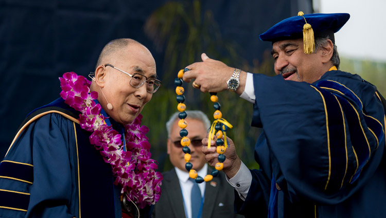 Chancellor Pradeep Khosla presenting His Holiness the Dalai Lama with a garland and string of beads after awarding the USCD medal at the UCSD Commencement ceremony in San Diego, CA, on June 17, 2017. Photo by Erik Jepsen/UC San Diego