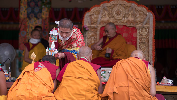 An assistant touching a ritual object to the head of senior monks during the Avalokiteshvara Permission given by His Holiness the Dalai Lama in Disket, Nubra Valley, J&K, India on July 12, 2017. Photo by Tenzin Choejor/OHHDL