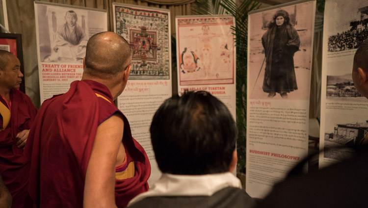 His Holiness the Dalai Lama looking at an exhibition focused on Agvan Dorjiev on his arrival at the hall for the dialogue between Russian and Buddhist scholars in New Delhi, India on August 7, 2017. Photo by Tenzin Choejor/OHHDL