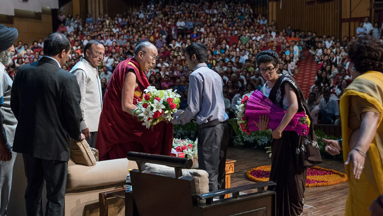 The welcoming committee of the Association of British Scholars offering His Holiness the Dalai Lama garlands of flowers at the start of his talk at the Siri Fort Auditorium in New Delhi, India on August 10, 2017. Photo by Tenzin Choejor/OHHDL