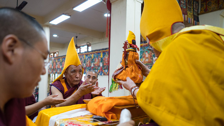 His Holiness the Dalai Lama installing the new Ganden Tripa before the start of his teaching at the Tsuglagkang in Dharamsala, HP, India on August 29, 2017. Photo by Tenzin Choejor/OHHDL