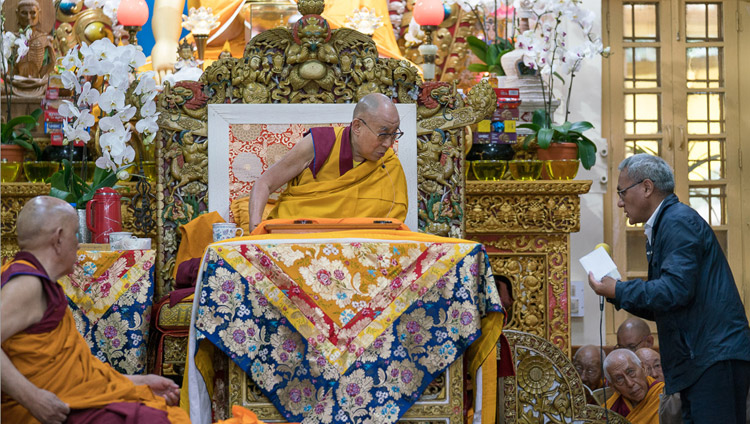 The English interpreter reading questions from the audience during a break in His Holiness the Dalai Lama's teaching at the Tsuglagkang in Dharamsala, HP, India on August 29, 2017. Photo by Tenzin Phuntsok/OHHD