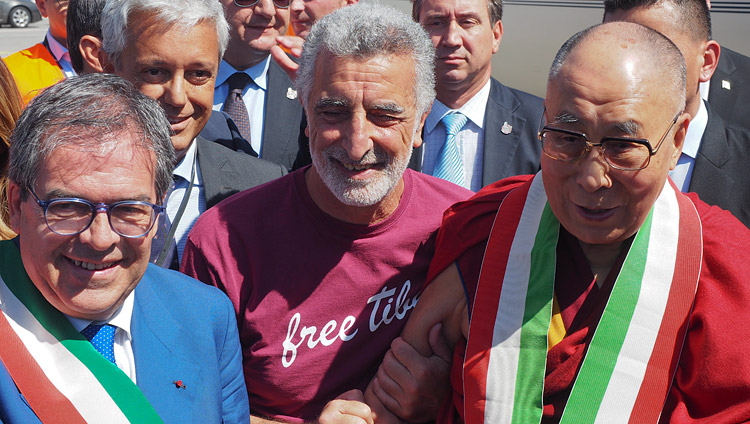 His Holiness the Dalai Lama being greeted at the airport by the Mayor of Catania, Enzo Bianco, and the Mayor of Messina, Renato Accorinti on his arrival in Catania, Sicily, Italy on September 15, 2017. Photo by Jeremy Russell