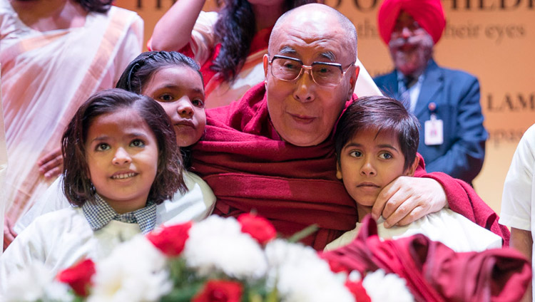 His Holiness the Dalai Lama with young children supported by the Smile Foundation before his talk at the NCUI Auditorium in New Delhi, India on November 19, 2017. Photo by Tenzin Choejor