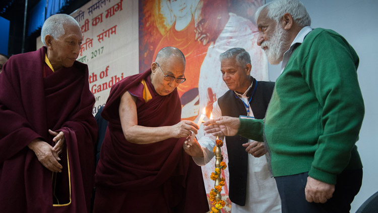 His Holiness the Dalai Lama joins in lighting a lamp to open the Convention for Global Peace at the Government College in Dharamsala, HP, India on December 2, 2017. Photo by Lobsang Tsering