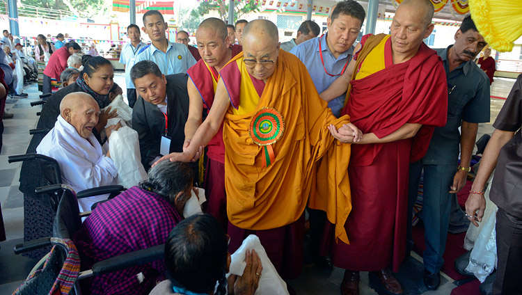 His Holiness the Dalai Lama greeting elderly Tibetans as he arrives at the new debate yard at Jangchub Choeling Nunnery in Mundgod, Karnataka, India on December 15, 2017. Photo by Lobsang Tsering