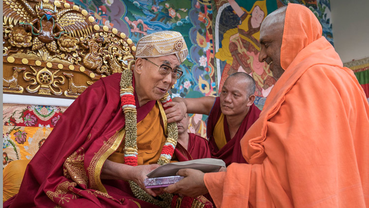 One of the chief guests, Jagadguru Sri Shivarathri, offering His Holiness the Dalai Lama a shawl, a garland and a turban as a token of appreciation during the inauguration ceremony for the new debate courtyard at Sera Mey Monastery in Bylakuppe, Karnataka, India on December 21, 2017. Photo by Lobsang Tsering