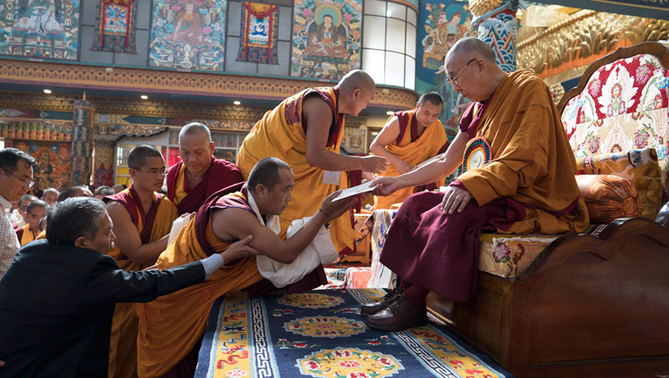 His Holiness the Dalai Lama handing out certificates of graduation to students at Namdroling Monastery's Seventh Convocation in Bylakuppe, Karnataka, India on December 22, 2017. Photo by Tenzin Choejor