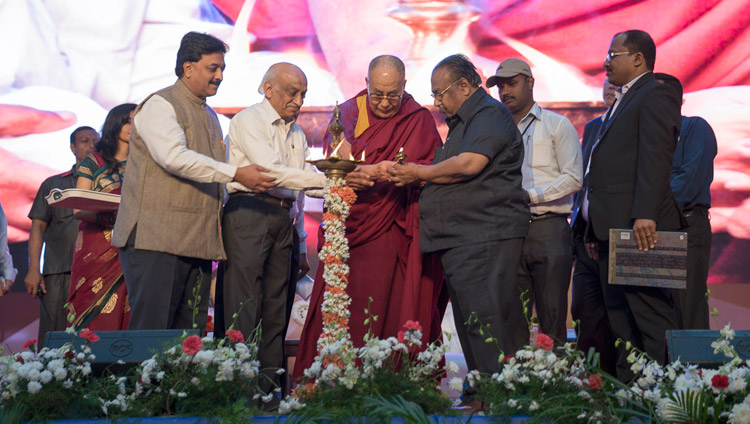 His Holiness the Dalai Lama joins in lighting a lamp at the start of the Seshadripuram Group of Institutions Silver Jubilee in Bengaluru, Karnataka, India on December 24, 2017. Photo by Lobsang Tsering