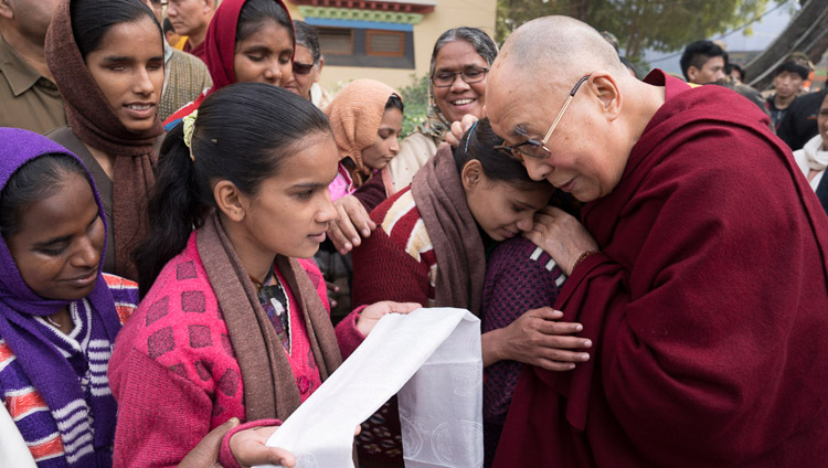 His Holiness the Dalai Lama with a group of blind and partially sighted women and girls from the nearby Jeevan Jyoti school outside the venue at the conclusion of the conference on Mind in Indian Philosophical Schools of Thought and Modern Science at the Central Institute of Higher Tibetan Studies in Sarnath, Varanasi, India on December 31, 2017. Photo by Lobsang Tsering