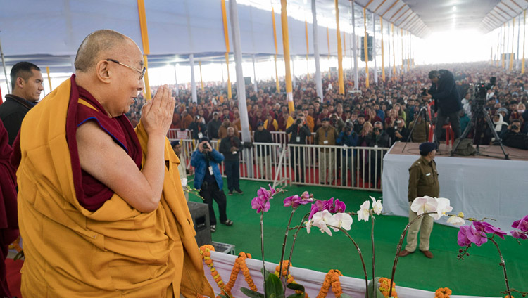 His Holiness the Dalai Lama acknowledging the crowd of over 50,000 on his arrival at the Kalachakra Maidan in Bodhgaya, Bihar, India on January 5, 2018. Photo by Lobsang Tsering