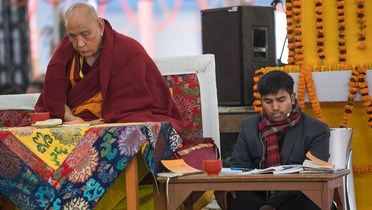 The Hindi interpreter sitting on stage at the teachings of His Holiness the Dalai Lama in Bodhgaya, Bihar, India on January 6, 2018. Photo by Lobsang Tsering