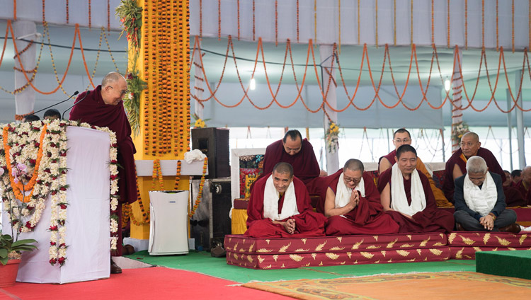 His Holiness the Dalai Lama thanking the Geshes who undertook the research work for the original compilation in Tibetan during the release ceremony for "Science and Philosophy in the Indian Buddhist Classics, Vol. 1: The Physical World" in Bodhgaya, Bihar, India on January 7, 2018. Photo by Lobsang Tsering