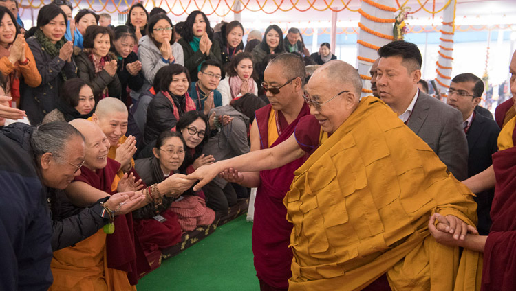 His Holiness the Dalai Lama greeting members of the audience as he arrives at the Kalachakra Maidan in Bodhgaya, Bihar, India on January 16, 2018. Photo by Manuel Bauer