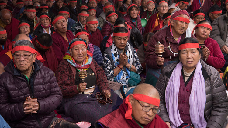 Members of the audience wearing ritual blindfolds listening to His Holiness the Dalai Lama during the Avalokiteshvara Empowerment in Bodhgaya, Bihar, India on January 16, 2018. Photo by Manuel Bauer