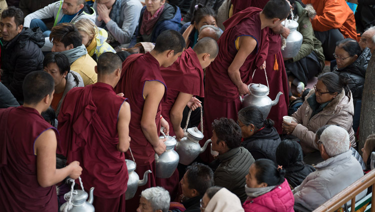 Volunteers serving tea to members of the crowd at the start of Monlam teachings at the Main Tibetan Temple courtyard in Dharamsala, HP, India on March 2, 2018. Photo by Tenzin Choejor