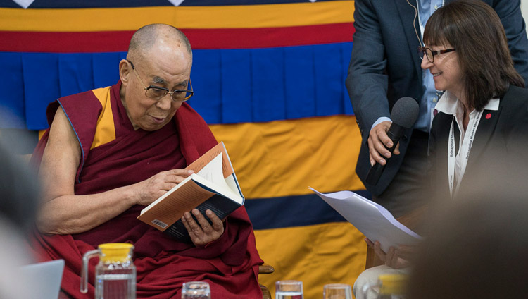 Susan Bauer-Wu, President of the Mind & Life Institute, presenting His His Holiness the Dalai Lama with a copy of ‘The Monastery and The Microscope’, a record of the dialogue that took place in Mundgod in 2013 on the opening day of the 33rd Mind & Life Conference in Dharamsala, HP, India on March 12, 2018. Photo by Tenzin Choejor