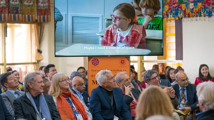 Members of the audience watching a short film clip as part of Tara Wilke's presentation on the second day of the 33rd Mind & Life Conference at the Main Tibetan Temple in Dharamsala, HP, India on March 13, 2018. Photo by Tenzin Choejor