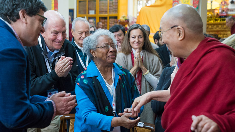 His Holiness the Dalai Lama greeting members of the audience as he arrives for the fourth day of the Mind & Life Conference at the Main Tibetan Temple in Dharamsala, HP, India on March 15, 2018. Photo by Tenzin Choejor