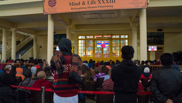 Members of the public watching His Holiness the Dalai Lama on TVs in the courtyard of the Main Tibetan Temple on the fourth day of the Mind & Life Conference in Dharamsala, HP, India on March 15, 2018. Photo by Tenzin Choejor