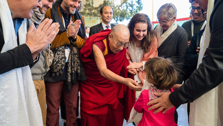 His Holiness the Dalai Lama fondly greeting a young girl on his way to Main Tibetan Temple to participate on the final day of the Mind & Life Conference in Dharamsala, HP, India on March 16, 2018. Photo by Tenzin Choejor