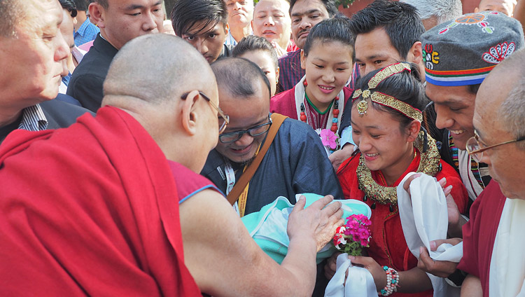 A couple presenting their new born baby to His Holiness the Dalai Lama for a blessing as he arrives at the Central Institute for Higher Tibetan Studies (CIHTS) in Sarnath, UP, India on March 19, 2018. Photo by Jeremy Russell