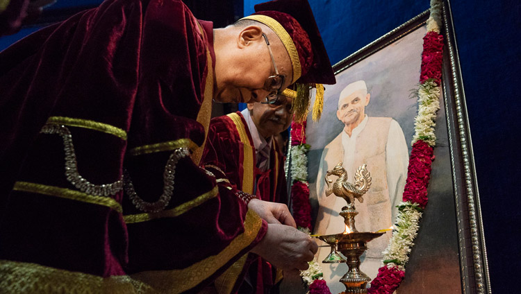 His Holiness the Dalai Lama lighting a lamp and offering flowers before a portrait of Lal Bahadur Shastri at the start of the Lal Bahadur Shastri Institute of Management Convocation in New Delhi, India on April 23, 2018. Photo by Tenzin Choejor