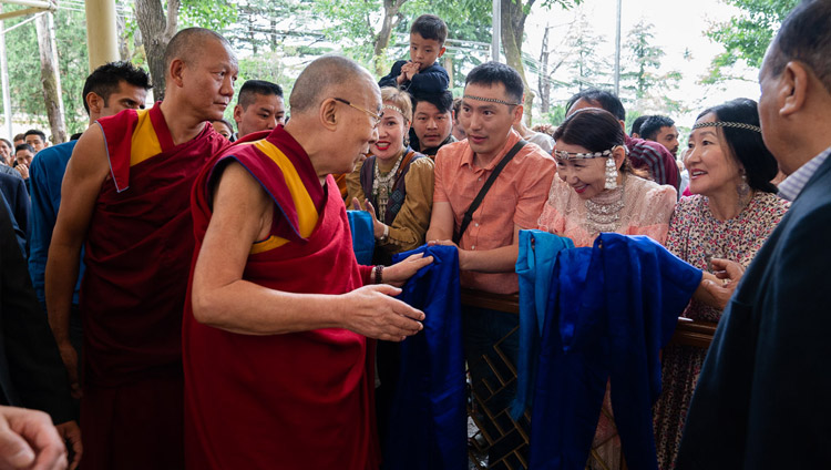 His Holiness the Dalai Lama greeting members of the public at the Main Tibetan Temple courtyard on his way to participate in the Dialogue Between Russian and Buddhist Scholars in Dharamsala, HP, India on May 3, 2018. Photo by Tenzin Choejor