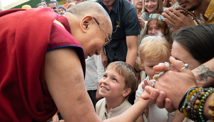 His Holiness the Dalai Lama greeting younger members of the audiences as he joins in group photos with people from around the world at the Tsuglagkhang courtyard in Dharamsala, HP, India on May 19, 2018. Photo by Tenzin Choejor