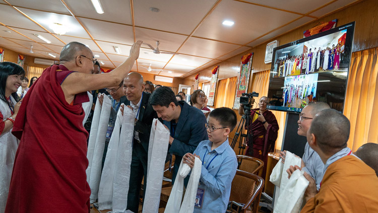 His Holiness the Dalai Lama waving to participants in Hanoi, Ho Chi Minh City and Hai Phong attending a meeting over a live teleconferencing link with a group from Vietnam at his residence in Dharamsala, HP, India on May 21, 2018. Photo by Tenzin Choejor