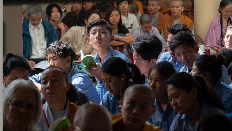 Tibetan students sitting on veranda at the Main Tibetan Temple listening to His Holiness the Dalai Lama during the second day of his teaching in Dharamsala, HP, India on June 7, 2018. Photo by Tenzin Phuntsok