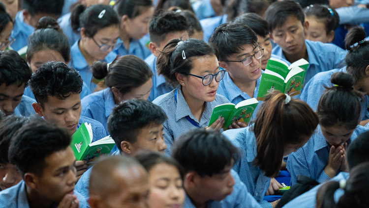 Young students following the text as His Holiness the Dalai Lama reads from the ‘Guide to the Bodhisattva’s Way of Life’ on the final day of his teachings for young Tibetan students at the Main Tibetan Temple in Dharamsala, HP, India on June 8, 2018. Photo by Tenzin Choejor