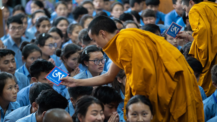 Assistants moving among the audience with ritual objects as His Holiness the Dalai Lama gives the the White Manjushri permission on the final day of his teachings for young Tibetan students at the Main Tibetan Temple in Dharamsala, HP, India on June 8, 2018. Photo by Tenzin Choejor