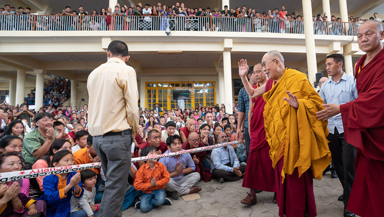 His Holiness the Dalai Lama waving to members of the audience sitting in the Main Tibetan Temple courtyard as he returns to his residence at conclusion his teachings for young Tibetan students at the Main Tibetan Temple in Dharamsala, HP, India on June 8, 2018. Photo by Tenzin Choejor