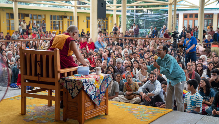 A member of the audience asking His Holiness the Dalai Lama a question during his meeting with visitors from India and abroad at the Main Tibetan Temple courtyard in Dharamsala, HP, India on June 9, 2018. Photo by Tenzin Choejor A member of the audience asking His Holiness the Dalai Lama a question during his meeting with visitors from India and abroad at the Main Tibetan Temple courtyard in Dharamsala, HP, India on June 9, 2018. Photo by Tenzin Choejor
