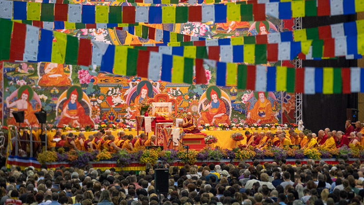 A view of the stage with His Holiness the Dalai Lama on the first day of his teachings at Skonto Hall in Riga, Latvia on June 16, 2018. Photo by Tenzin Choejor A view of the stage with His Holiness the Dalai Lama on the first day of his teachings at Skonto Hall in Riga, Latvia on June 16, 2018. Photo by Tenzin Choejor