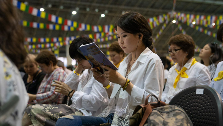 Members of the audience reading the texts along with His Holiness the Dalai on the second day of his three day teaching in Riga, Latvia on June 17, 2018. Photo by Tenzin Choejor