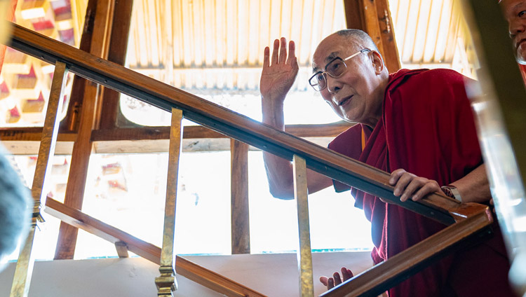 His Holiness the Dalai Lama waving to the gathered guests as he climbs the stairs to his residential quarters in Leh, Ladakh, J&K, India on July 3, 2018. Photo by Tenzin Choejor